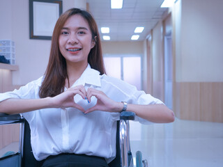 Female woman girl lady person people human looking at camera beautiful pretty body part hand finger love heart symbol concept romance breast cancer awareness happy valentine lifestyle wheelchair 