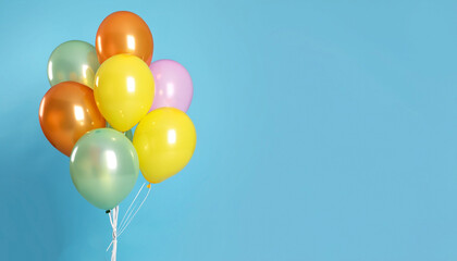 Bunch of bright balloons on light blue background, space for text. Banner design