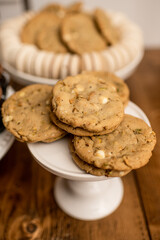 White chocolate pistachio cookies on a white cake tray