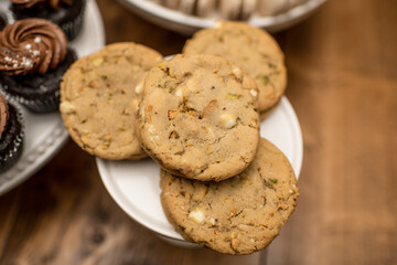 White chocolate pistachio cookies on a white cake tray