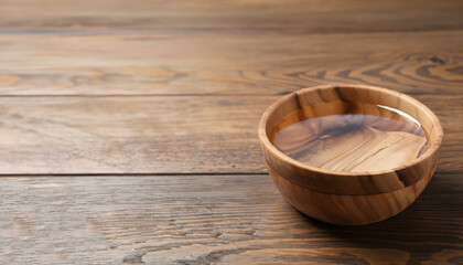 Bowl with clear water on wooden table. Space for text