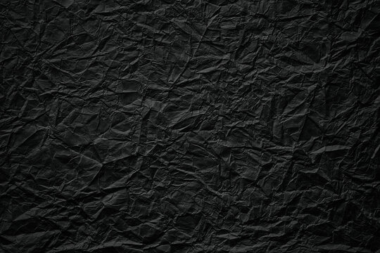 crumpled paper texture, black cardboard sheet, gloomy background