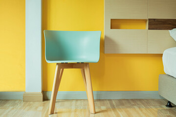 Green chair in the yellow bedroom.