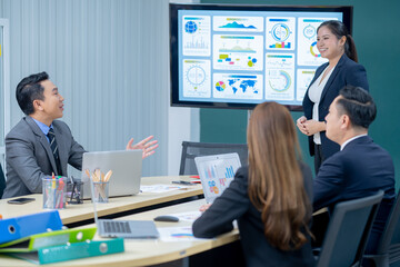 Office Conference Business Meeting Presentation: asian Business people group meeting Talks, Uses Wall TV to Show Company Growth with Big Data Analysis, Graphs, Charts, Infographics, e-Commerce Startup