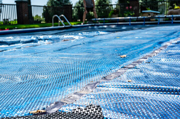 Single leave on a retractable floating pool cover to keep out leaves and keep in heat.