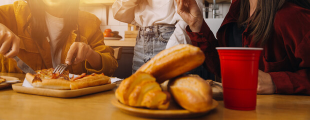 .Friends hangout. Young female celebrating birthday party at weekend at home, eating pizza, drinking champagne, party, lifestyle, friendship