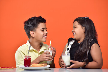 kid Girl and boy drinking milk 