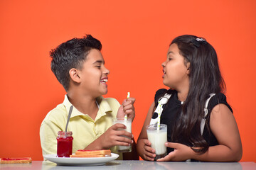 kid Girl and boy drinking milk 
