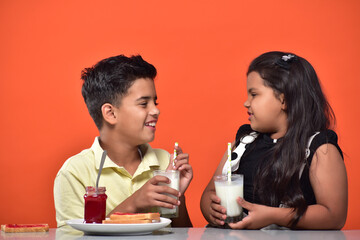 kid Girl and boy drinking milk 