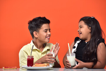 kid Girl and boy drinking milk 