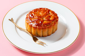 A mooncake  is a Chinese bakery product traditionally eaten during the Mid-Autumn Festival.