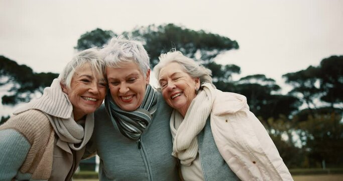 Talking, laughing and elderly friends hugging outdoor in a park together for bonding during retirement. Love, smile and funny with a happy group of senior women joking in a garden for humor or fun
