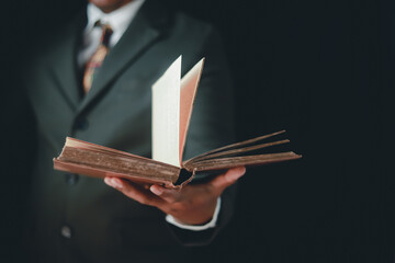 Asian man reading holy bible and crucifix according to divine teaching according to his faith and faith in god religious concept