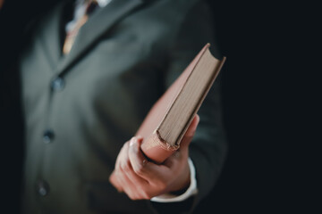 Asian man reading holy bible and crucifix according to divine teaching according to his faith and faith in god religious concept