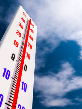 Outdoor thermometer close-up against the sky shows high air temperature.