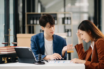 Business people compassionately holding hands and discussing contract papers with laptop and...