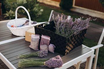 Bouquets of fresh lavender and bags with dried lavender on table