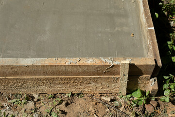 Formwork at construction site. Poured cement. Details of construction.