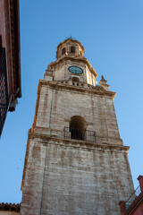 Bell tower of the church in the town of Toro in Zamora, Spain, silhouetted against the blue sky