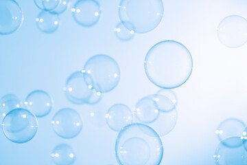 Beautiful Transparent Blue Soap Bubbles Floating in The Air. White Space, Abstract Fun Background,...