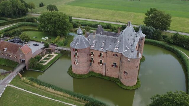 Ammersoyen castle: aerial view traveling in the beautiful castle and seeing the bridge and the moat that surrounds it. In the Netherlands on a sunny day.