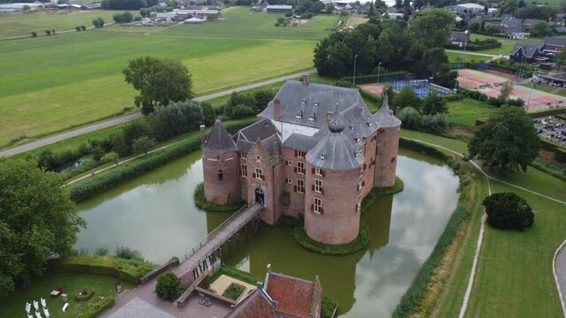 Ammersoyen castle: aerial view in orbit of the beautiful castle and the bridge and the moat that surrounds it. In the Netherlands on a sunny day.