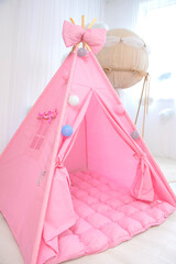 Playroom with Teepee. Modern room interior with play tent for child. pink children's wigwam in the...