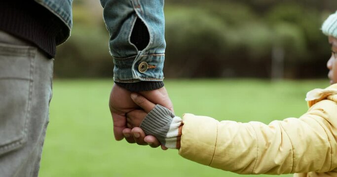 Parent, father or child holding hands in park in countryside nature together for support or care. Family, closeup or dad with kid bonding or walking on holiday vacation with love, unity or trust