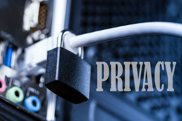Closed lock hanging on a network cable and word privacy. The concept of security or blocking the...