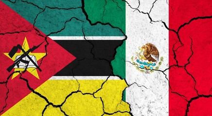 Flags of Mozambique and Mexico on cracked surface - politics, relationship concept