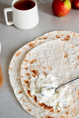 Cup of tea and lavash with curd cheese for breakfast.