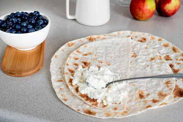 Cup of tea and lavash with curd cheese for breakfast.