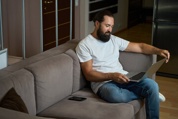 Fototapeta premium Hotel guest spends the evening in online communication