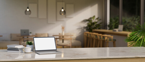 A laptop on a tabletop in a minimal Scandinavian coffee shop.