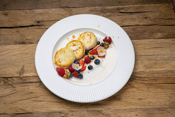 Delicious breakfast. cheesecakes with raspberries and blueberries. Close-up