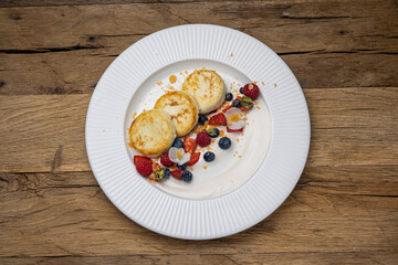Delicious breakfast. cheesecakes with raspberries and blueberries. Close-up