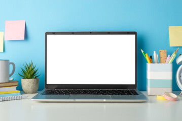Explore the online learning environment with a side view image of a white desk, laptop, small cactus and stationery against an isolated blue background, allowing for text or advertising integration