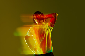 Inner self. Creative portrait of handsome young guy with neon filter reflection on gradient green...