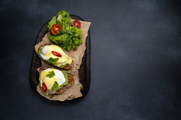 Delicious breakfast. poached eggs with avocado on toast. Close-up
