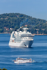 Naklejka premium Cruise ship and boat portrait format in the Mediterranean Sea Aegean island of Skiathos, Greece