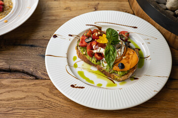 Сrouton with avocado, tomatoes and basil. 