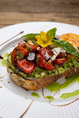 Сrouton with avocado, tomatoes and basil. 