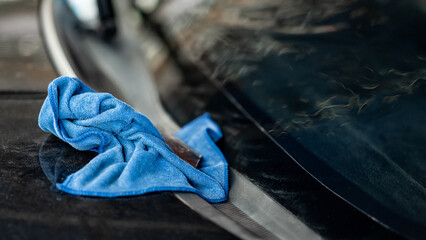 Blue cloth wipe or rag on front windscreen. Cleaning tool for car wash and car film tint...