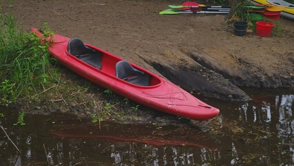  Red Two Seat Kayak Parked on River Bank