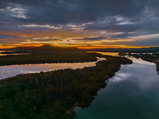 A moody winter sunrise waterscape with clouds