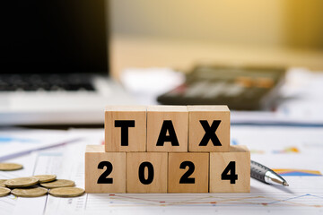 Tax 2024 icon in the wooden cube for income tax return and submit tax for payment tax documents...
