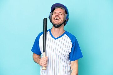 Baseball player with helmet and bat isolated on blue background laughing