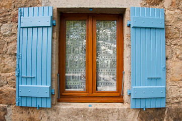 Obraz premium Blue shutters on French rural house in Auvergne region of France