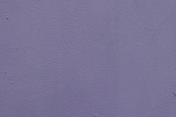 Texture of pale lavender colored painted wall with cracks