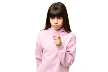 Little girl over isolated green chroma key background frustrated and pointing to the front